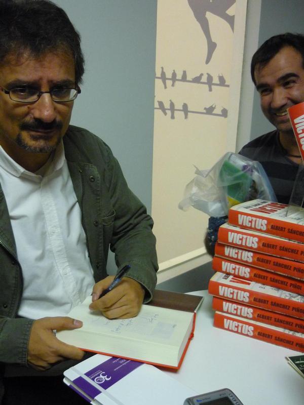 Writer Albert Sánchez signing one of his books